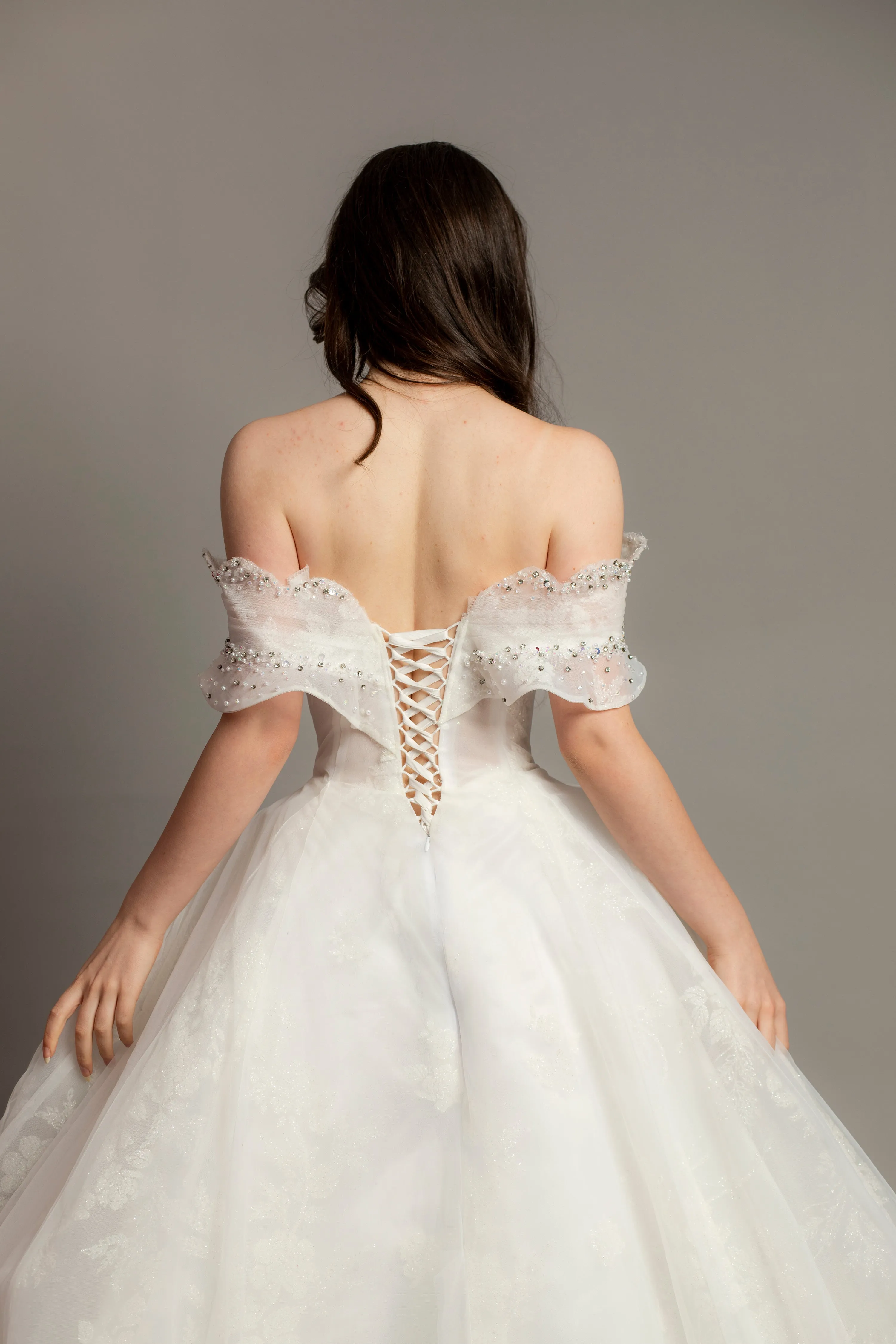 White wedding dress with asymmetrical bustier top and puffy layered skirt