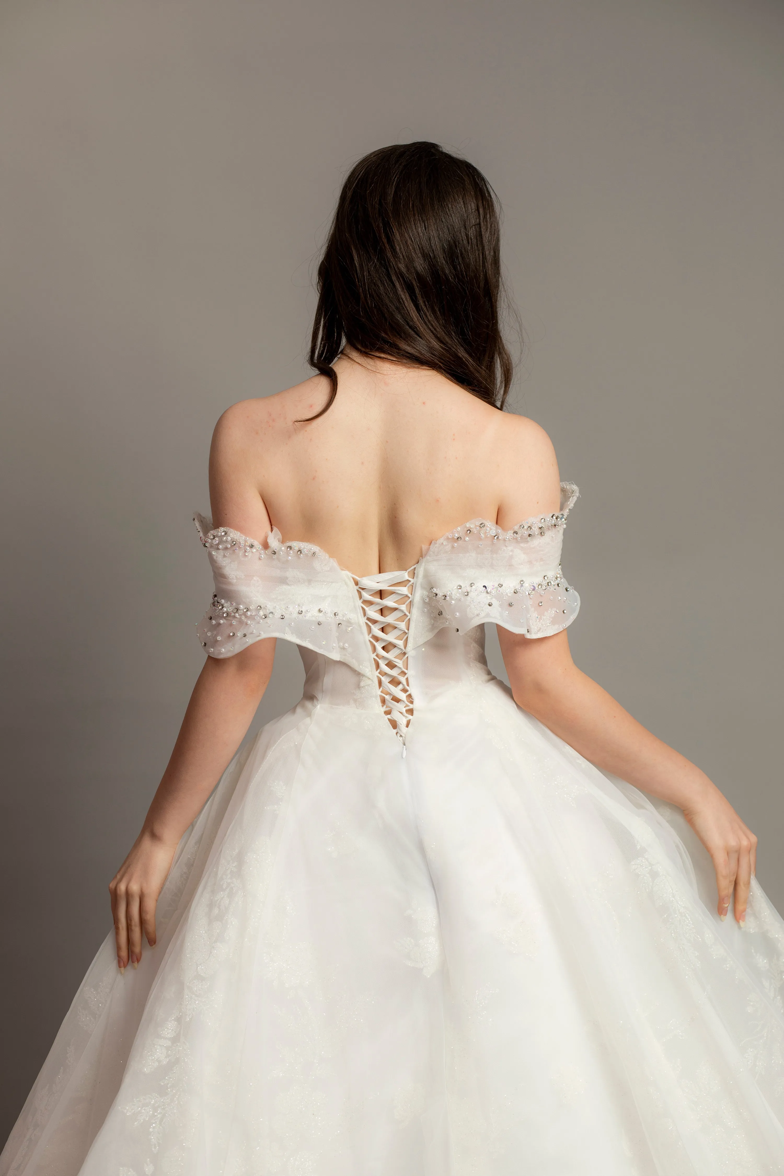 White wedding dress with asymmetrical bustier top and puffy layered skirt