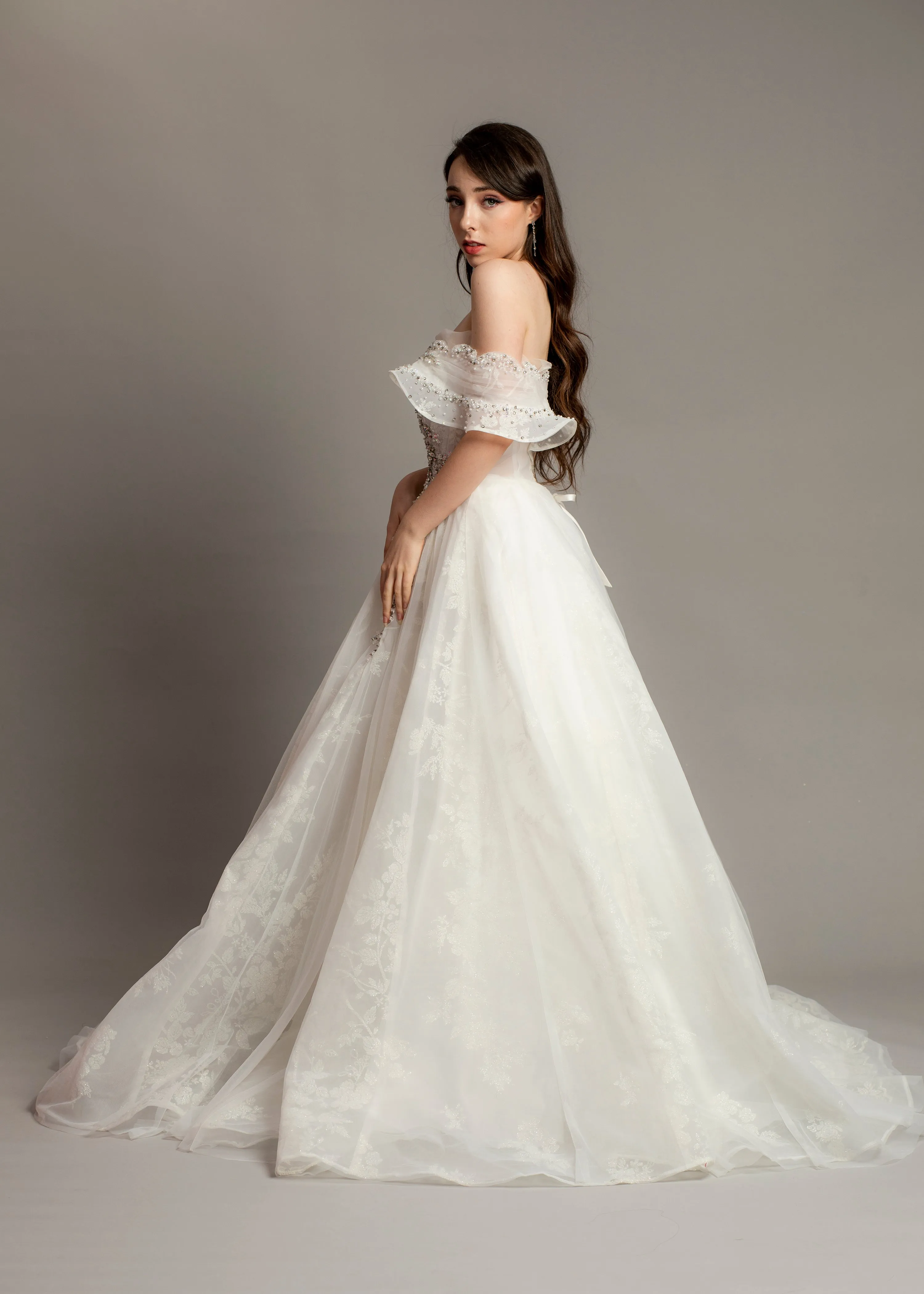 White wedding dress with asymmetrical bustier top and puffy layered skirt