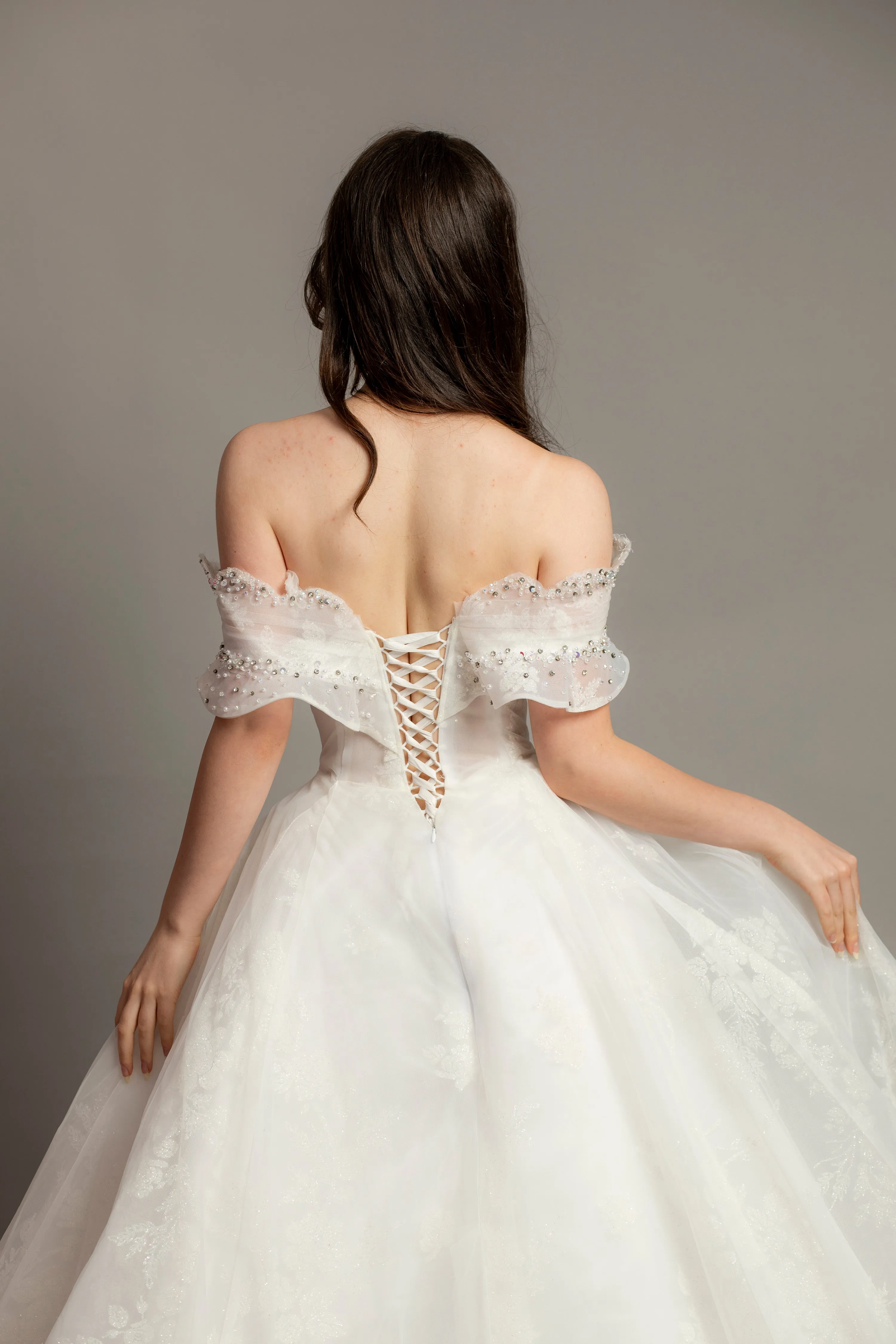 White wedding dress with asymmetrical bustier top and puffy layered skirt